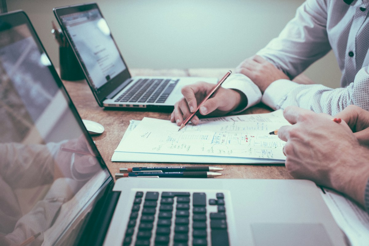 Professionals reviewing financial paperwork together at a desk